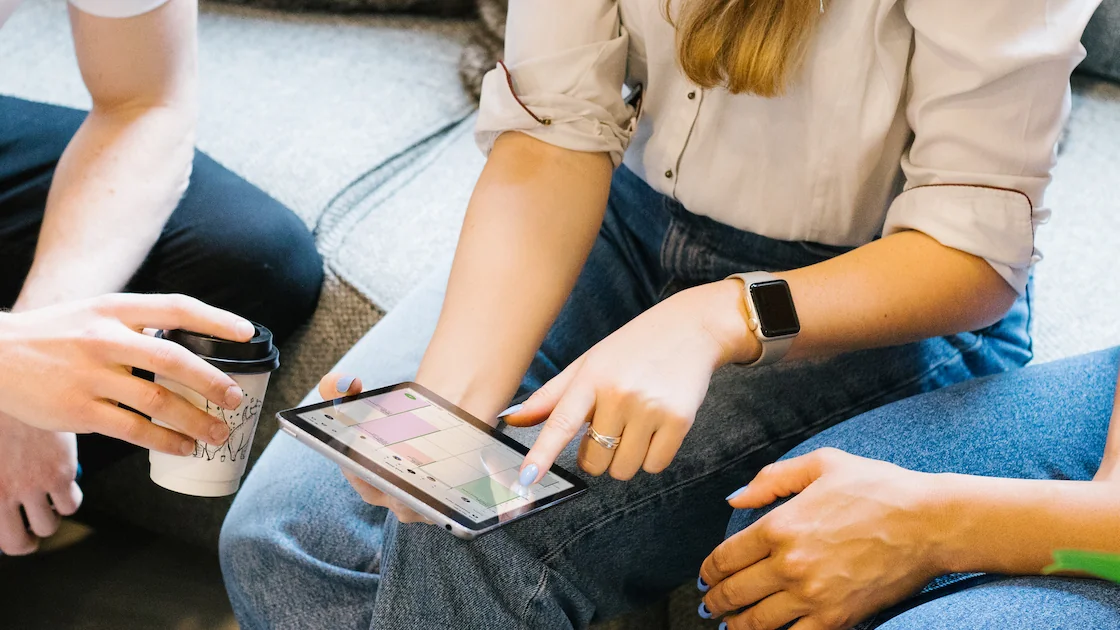 Salon team members checking their booking calendar on a tablet in Treatwell Connect
