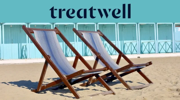 Two striped wooden deckchairs on the sand in front of pastel-blue beach huts on the Versilia coast