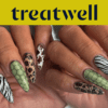 Two hands showing off long almond-shaped nails in assorted animal prints, including zebra stripes, leopard spots, green snakeskin and tortoiseshell.